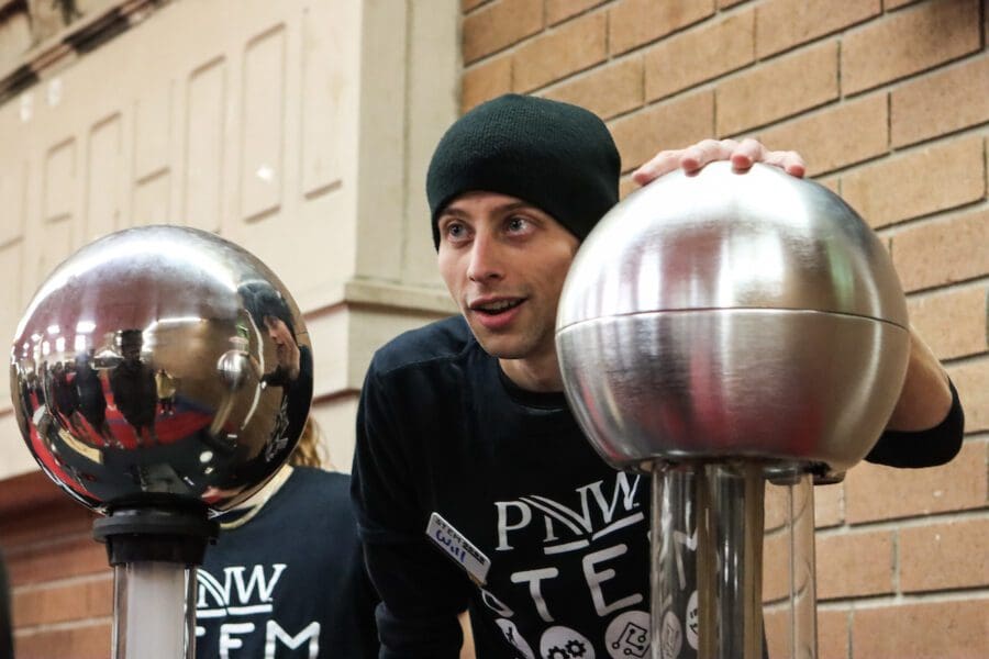 William Feithen, third-year Physics major, explains how a Van de Graaff generator works during a “STEM on the Road” visit to East Chicago Central High School.