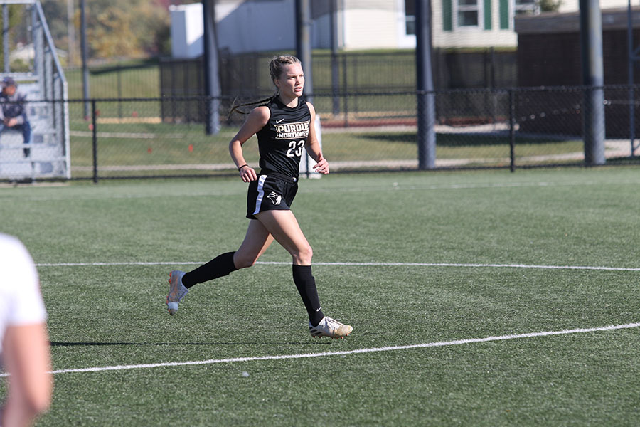 A PNW women's soccer player runs down field during a game