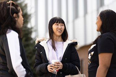 Students talk outside PNW's Nils K. Nelson Bioscience Innovation Building.