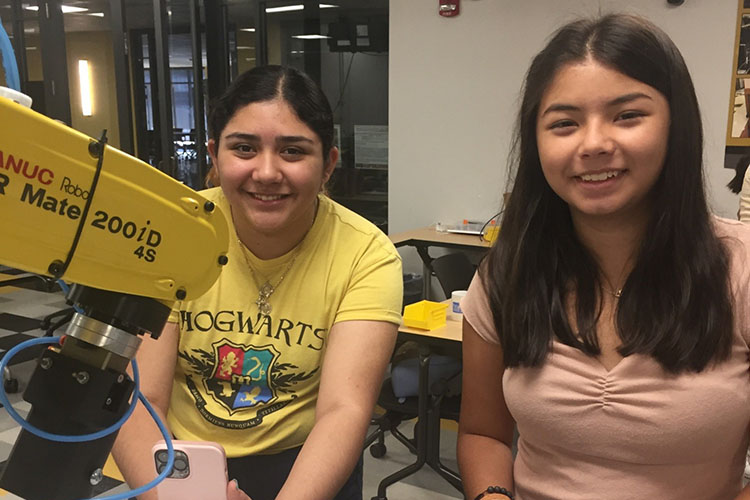 Students work with equipment at a PNW robotics camp