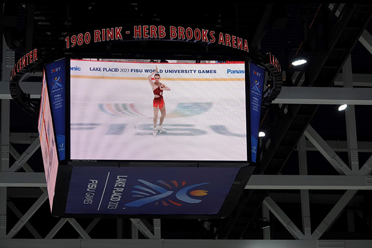 A screen shows Finley Hawk, standing on the ice, waving.