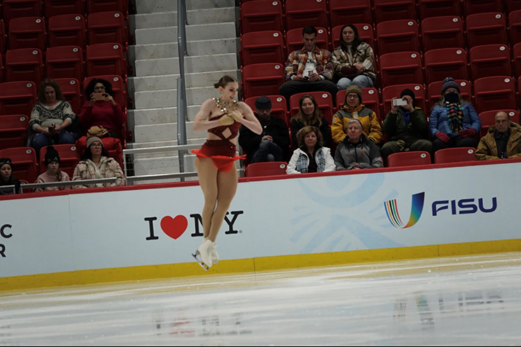 Finley Hawk mid-air on the ice.