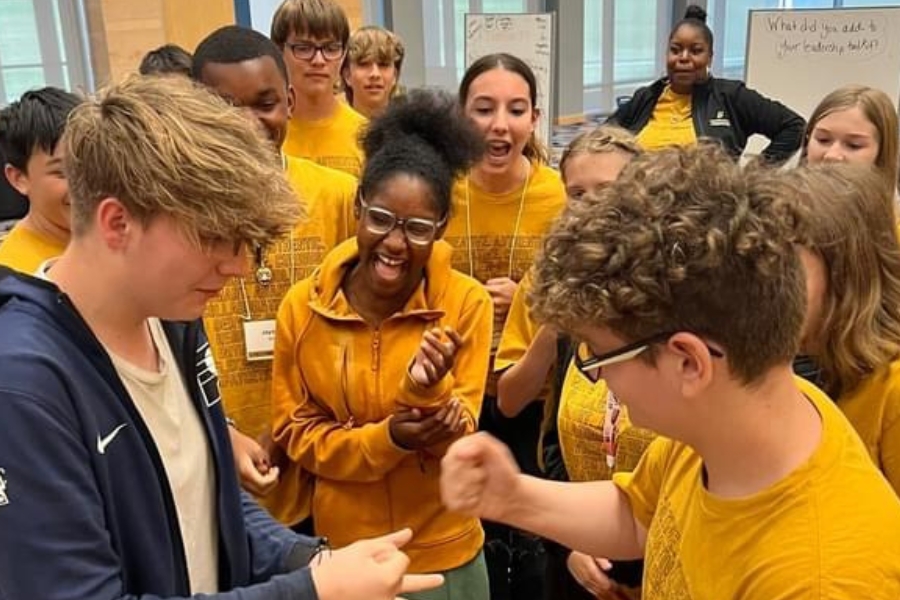Teens playing rock paper scissors
