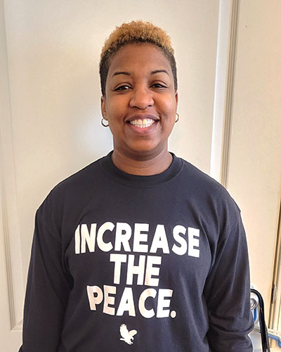 PNW student Toi wearing an "Increase the Peace" shirt