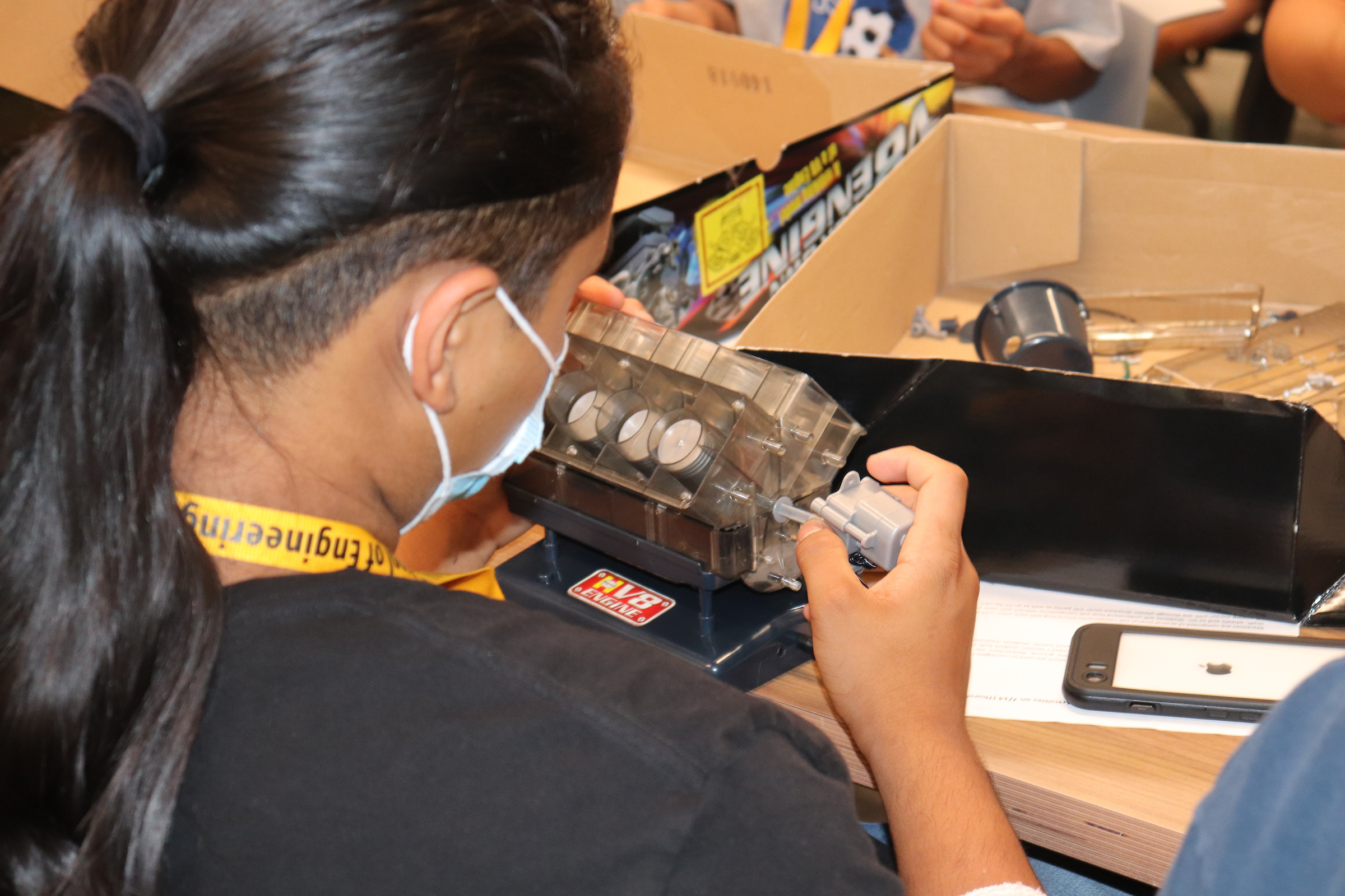 A participant in PNW summer engineering camp works with an electronic component.