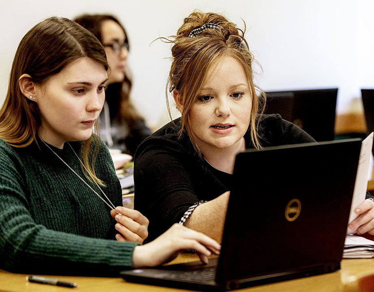 Two girls working on a computer
