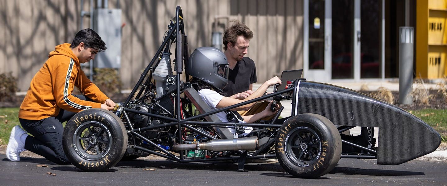 An engineering student in a race car.