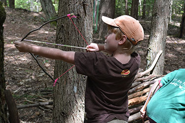 Kid shooting bow at Gabis Arboretum