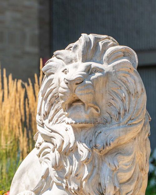 A lion sculpture in front of vegetation on PNW's Westville Campus.