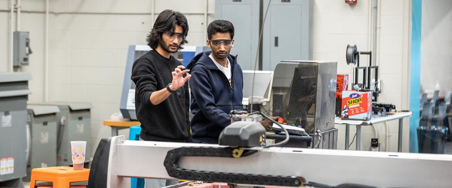 Students work with a water jet cutter