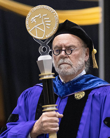 PNW faculty member Thomas Roach leading the procession at commencement.