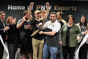 Esports Head Coach Justin Bragg cuts the ribbon during a grand opening ceremony for the Esports arena on PNW’s Westville campus.