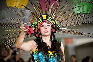 A person performs with the group Danzantes Aztecas