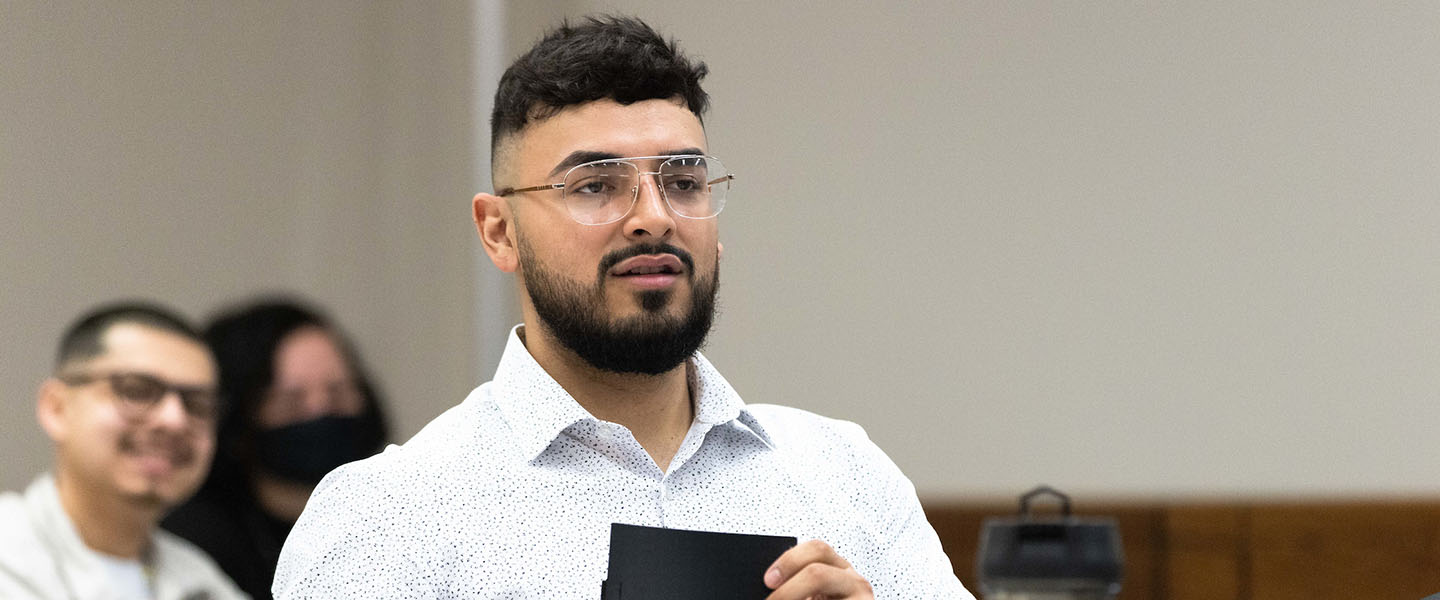 A PNW student takes notes in the classroom