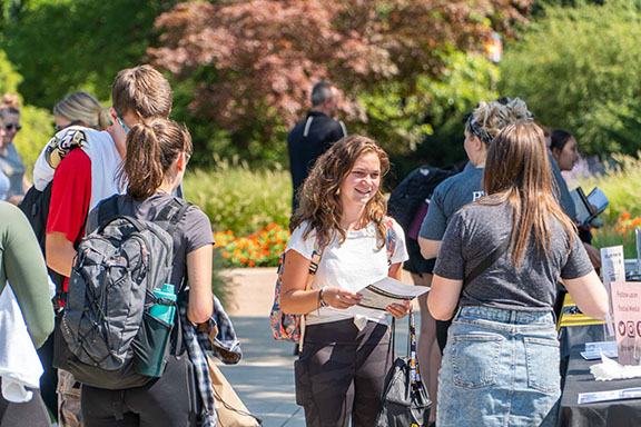 A group of students and staff stand together during a welcome rally