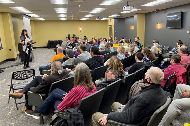 Erin Okamoto Protsman, left, continuing lecturer of Communication and Creative Arts, makes opening remarks during a screening of her co-produced documentary, “Without Due Process: A Documentary About America’s Concentration Camps.”