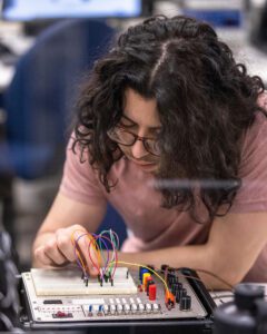 A student places wires into an electrical board