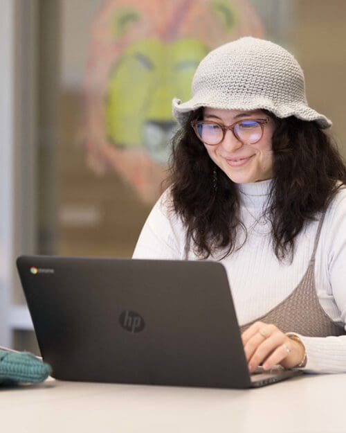 A PNW student works at a laptop