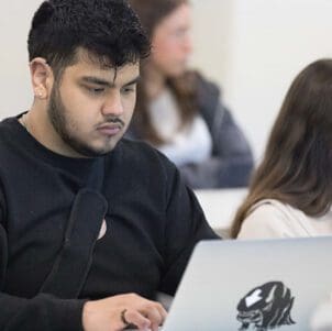 A PNW student works at a computer