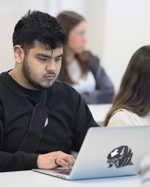 A PNW student works at a computer