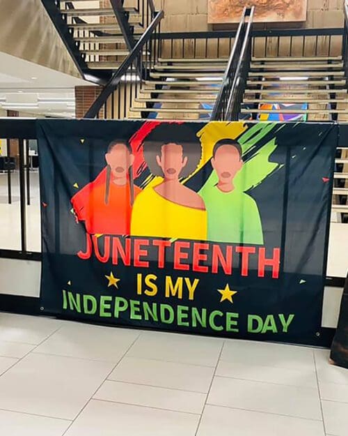 A flag that features three graphics of people and reads "Juneteenth is my independence day"