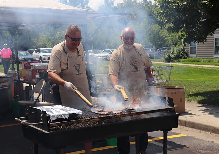 Two PNW Police Officers grill hamburgers