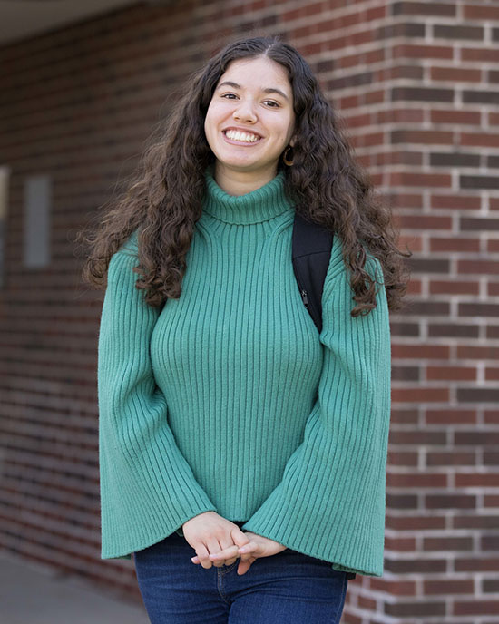 A PNW student stands outdoors