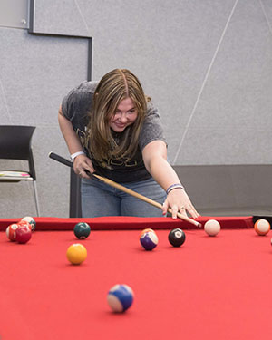 A student plays pool on PNW's Westville campus
