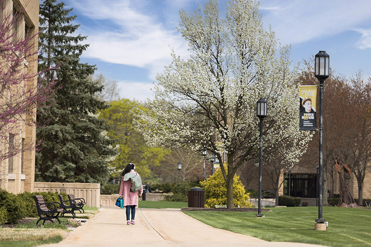 A student walks outdoors on PNW's Westville Branch Campus