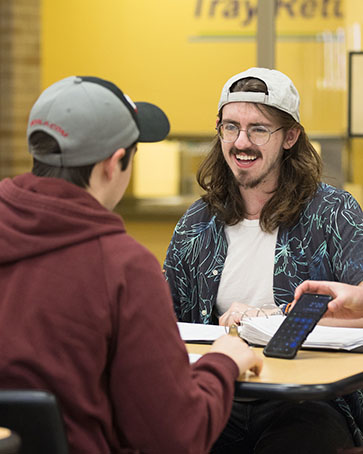 PNW students laugh in the cafeteria on the Westville branch campus.