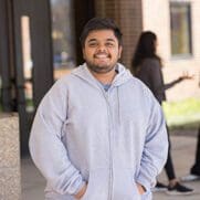 A PNW student stands on campus