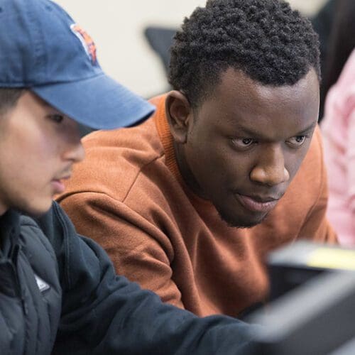 Two students collaborate at a computer