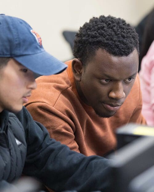 Two students collaborate at a computer