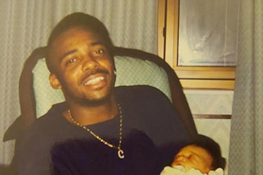 Cleveland “Christopher” Bynum and his son before his 2000 arrest for five killings in Gary that another man later confessed to. Photo from Chicago Sun-Times