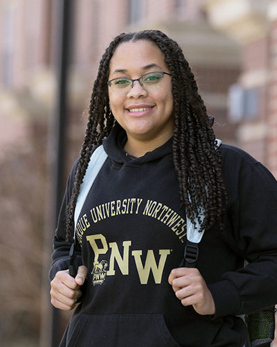 A PNW student in a Purdue Northwest hoodie on campus