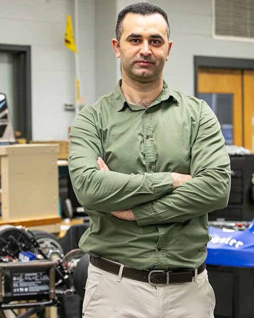 KHAIR AL SHAMAILEH, PH.D., Associate Professor of Electrical Engineering, stands in his lab