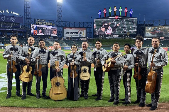 Mariachi Monumental De Mexico poses on the field at Guaranteed Rate Field.