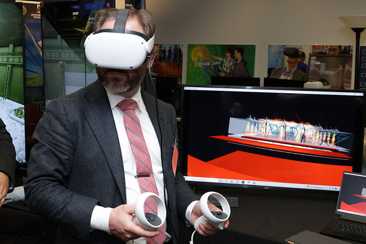 A man in a suit wears VR equipment