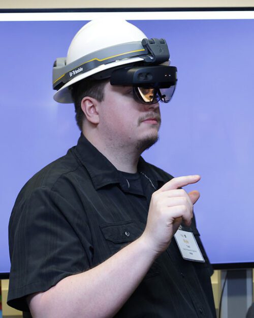 Kyle Toth wears a VR helmet.