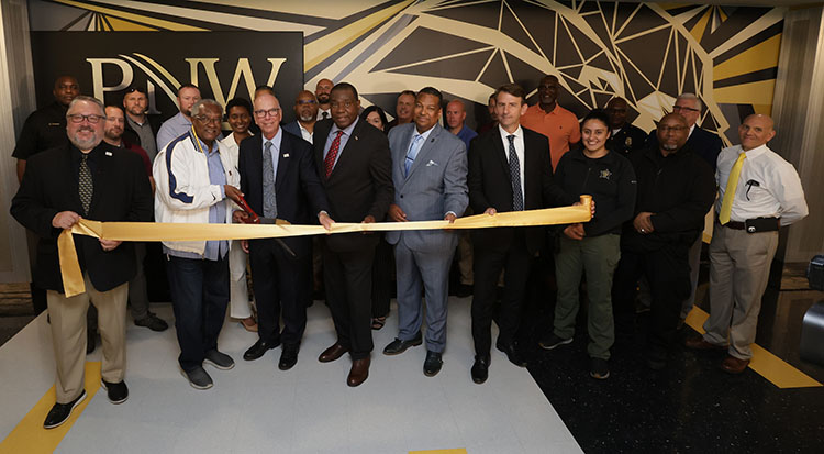 People gather during a ribbon-cutting on PNW's campus