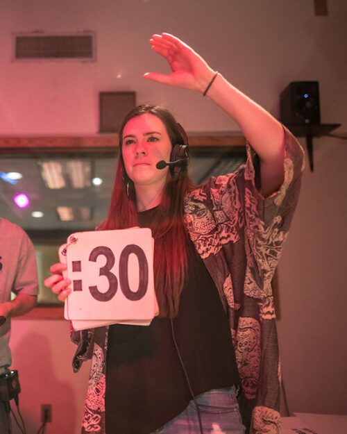 A PNW student holds up a sign that reads ":30" inside the broadcast production studio