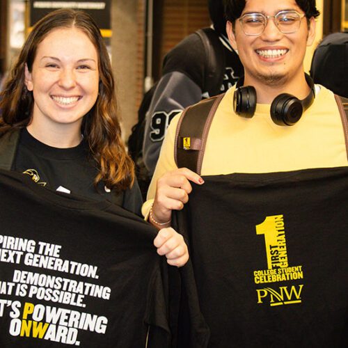 Two students stand together with First-Generation student t-shirts