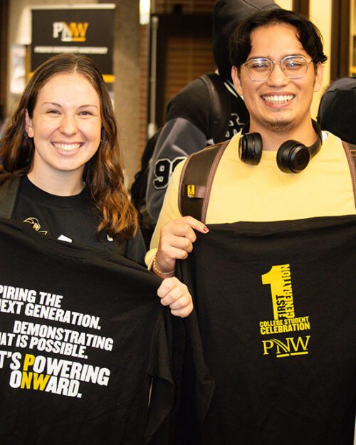 Two students stand together with First-Generation student t-shirts