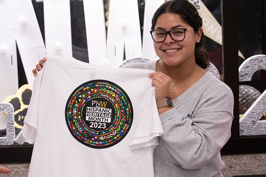 PNW Student Bianca Cortez holds up the 2023 Hispanic Heritage Month shirt