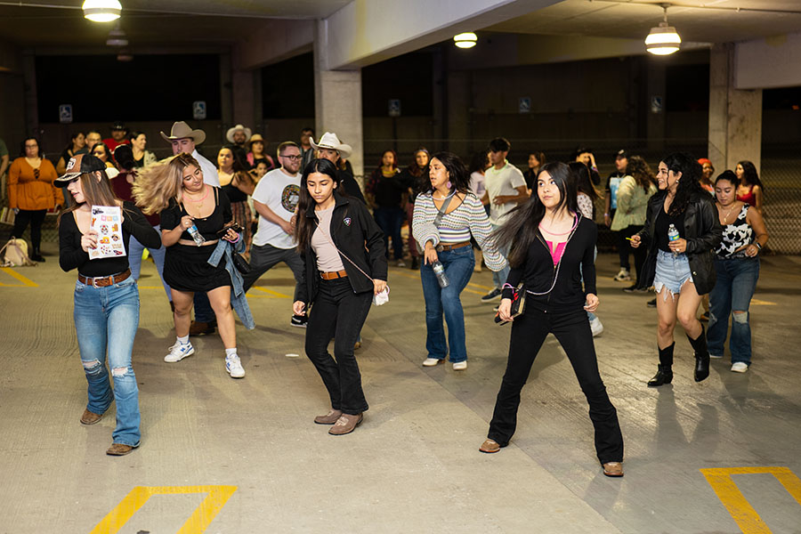 Concert attendees dance in the PNW parking garage