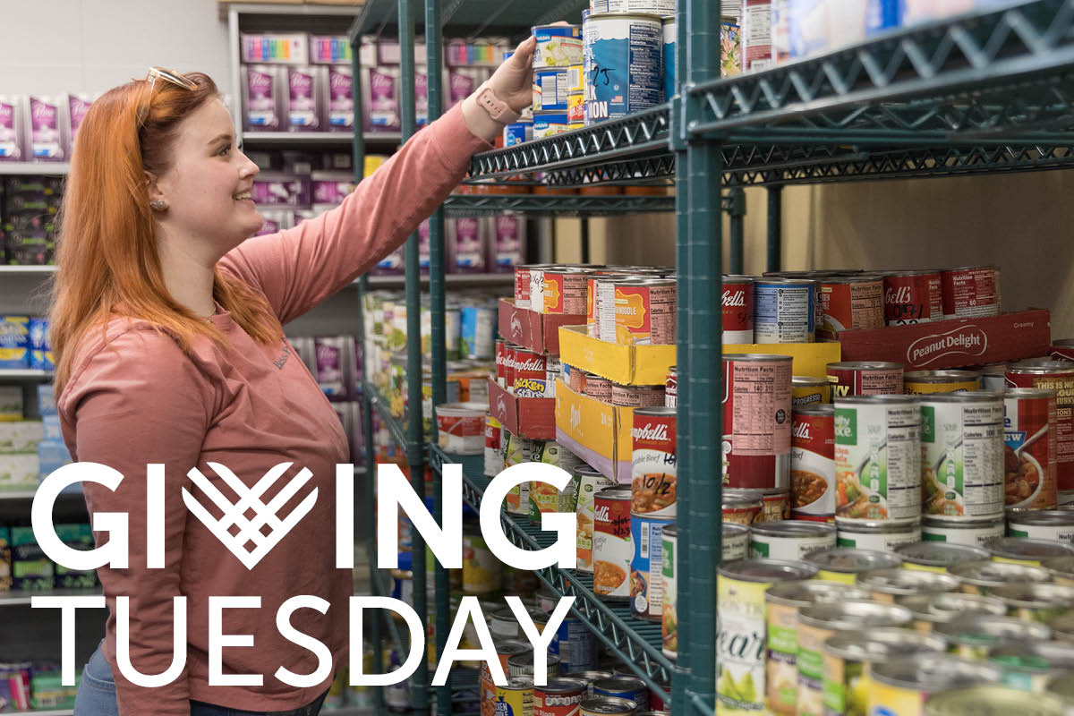 A student stocks shelves in the PNW Food Pantry. The Giving Tuesday logo is in the bottom left corner