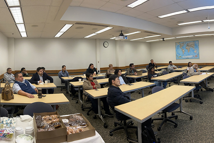 Students and faculty sit in a classroom