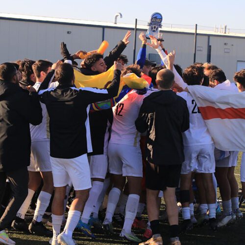 The PNW Men's Soccer team celebrates on the field after winning the GLIAC conference.