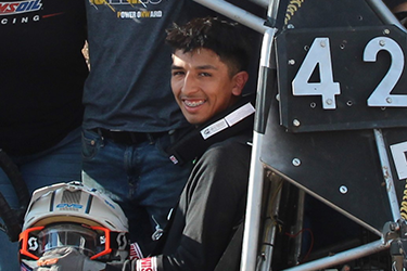 Azrael Jimenez sits in a baja car