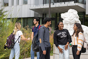 PNW students talk together in front of the Nils K. Nelson Bioscience Innovation Building